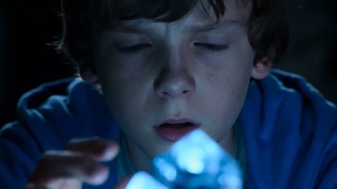 Boy Touches Glowing Crystal in Cave